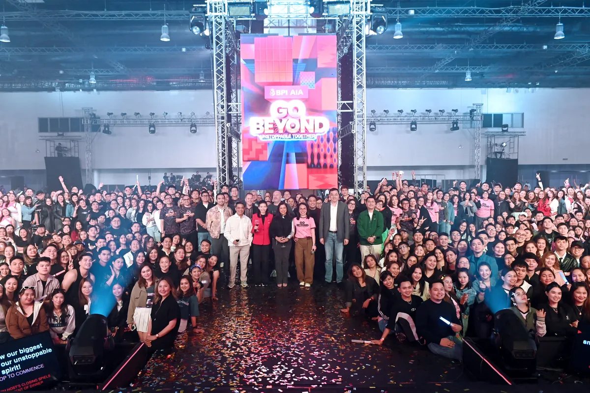AIA commitment-setting event with a packed audience and branded stage.