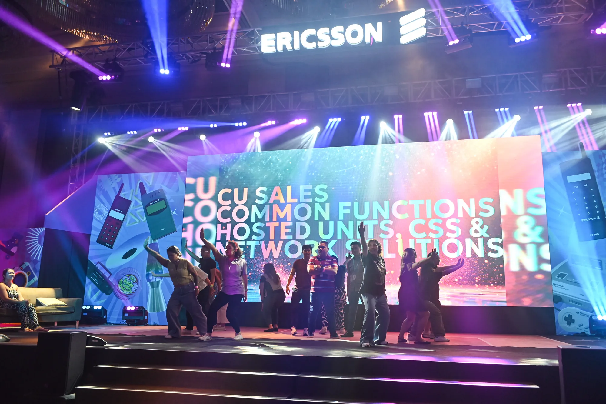Audience and setup viewed from behind during a corporate event.