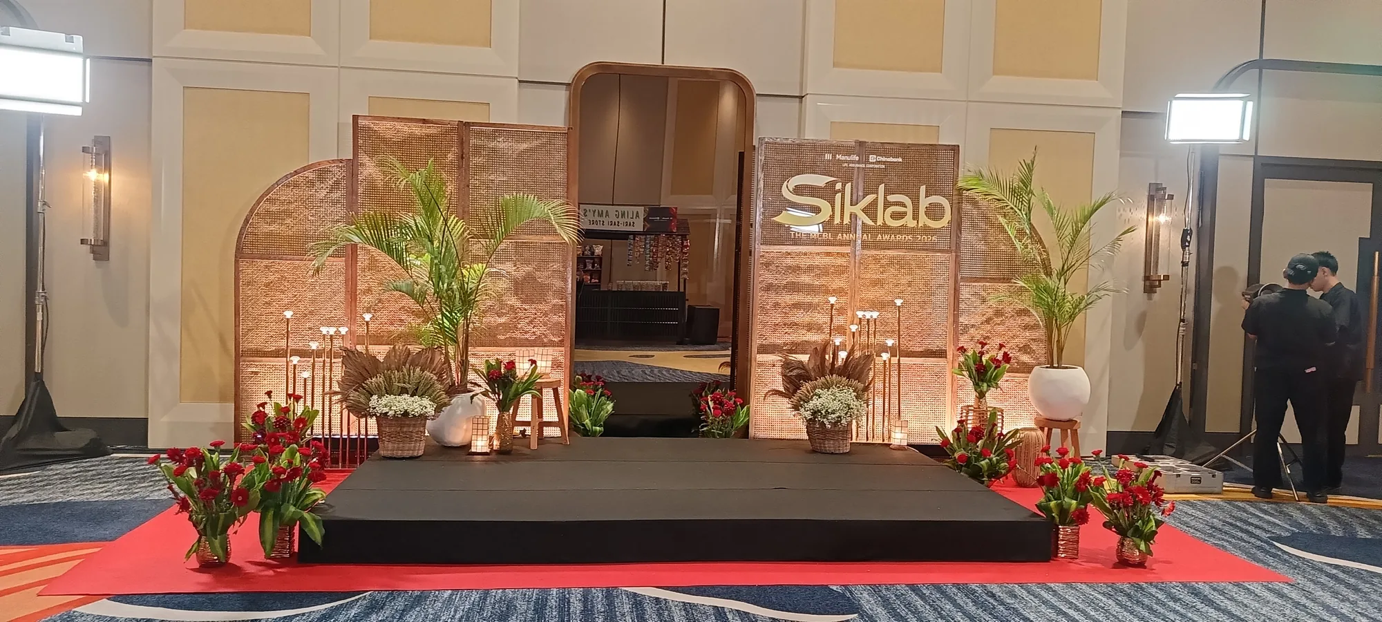 Wide event setup with lighting and stage atmosphere.